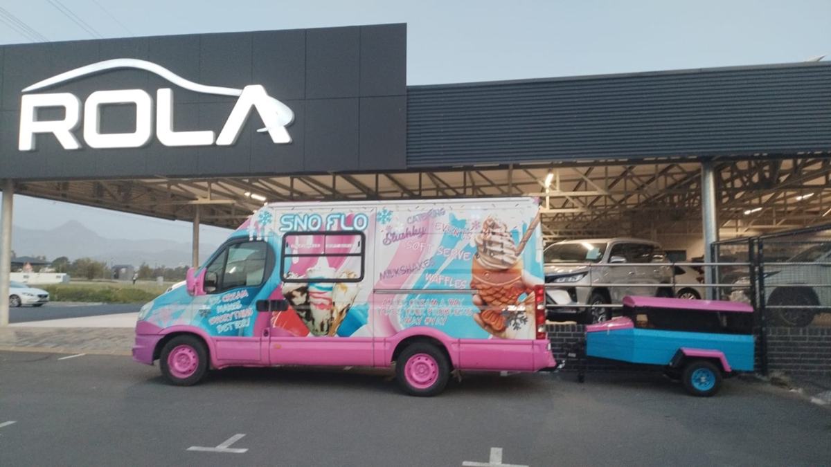 The SNO FLO bus parked at a Rola dealership