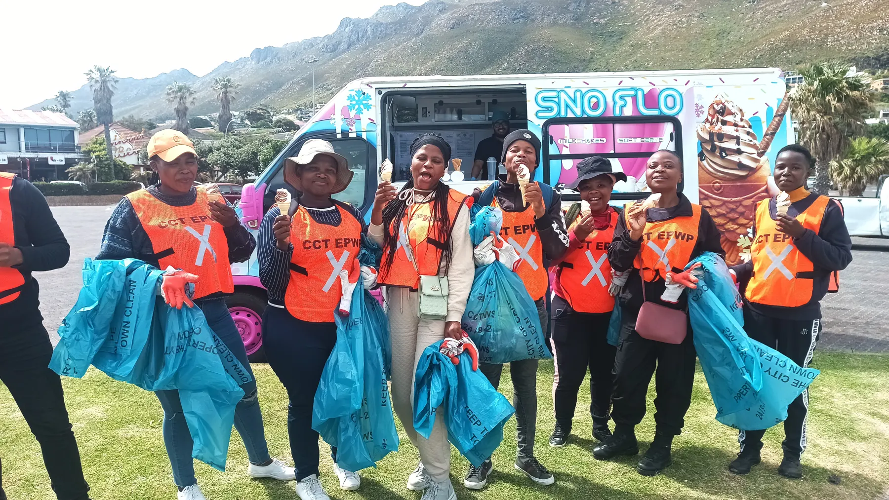 Volunteers with the SNO FLO bus at a community clean-up