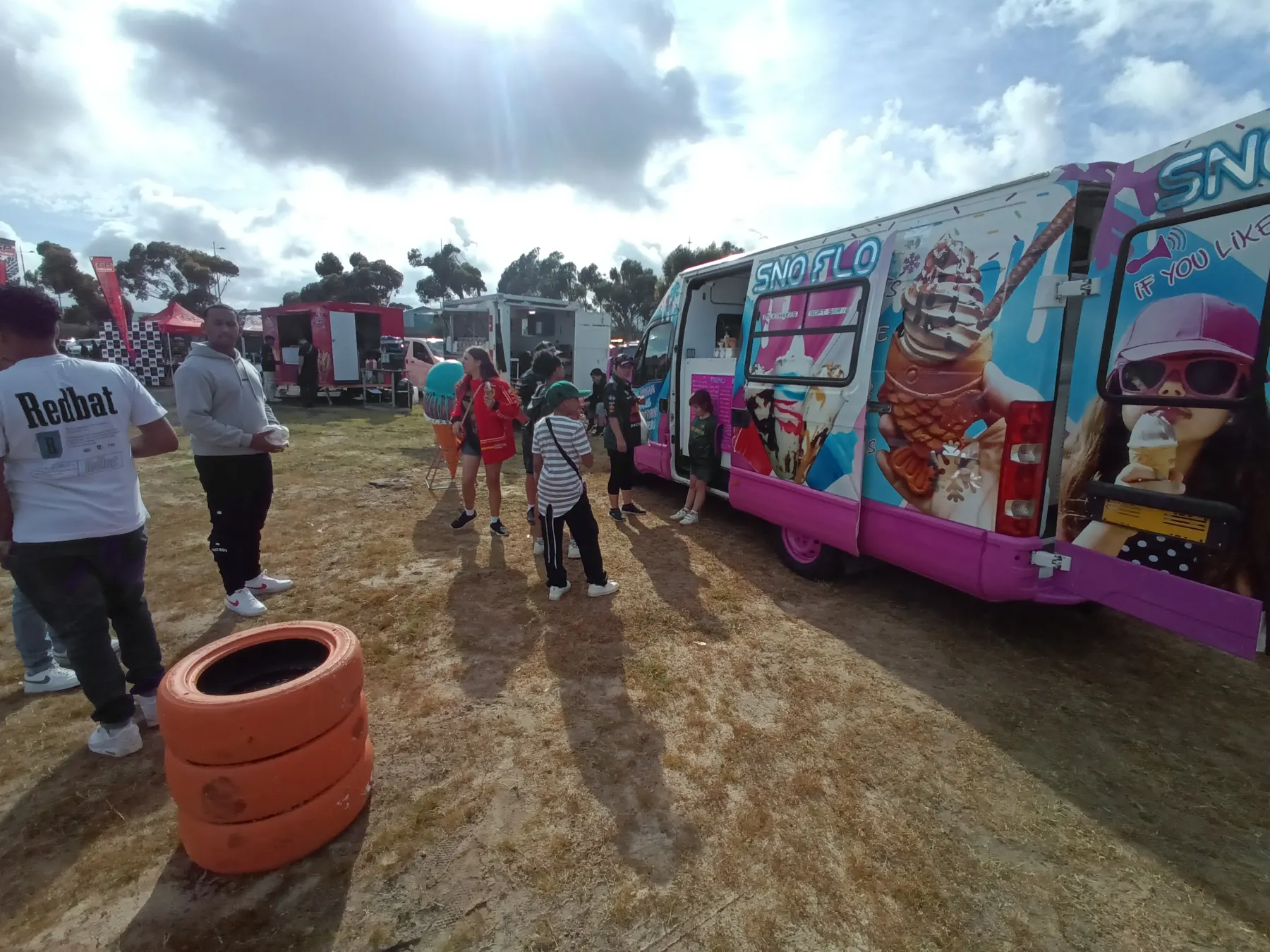 A crowd at the SNO FLO bus at a weekend market